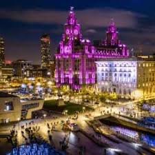 Vibrant night skyline of Liverpool with illuminated buildings, ideal for British IPTV services.